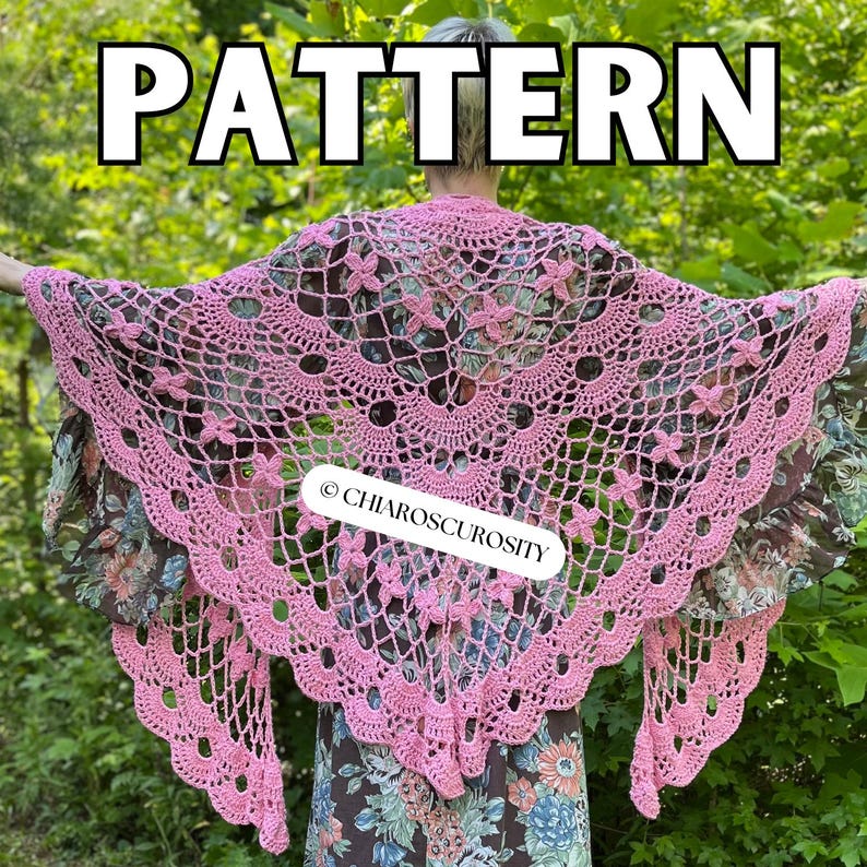 May include: A pink crocheted shawl with a floral design and scalloped edges. The word "PATTERN" is displayed in large white letters at the top of the image. The shawl is worn over a floral patterned dress. The text "CHIAROSCURISITY" is displayed on the shawl.