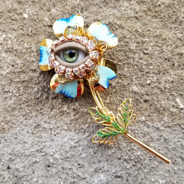 Blue Posey Wink - Gold toned vintage brooch + glass doll eye. OOAK mixed media jewelry. Floral fantasy art.