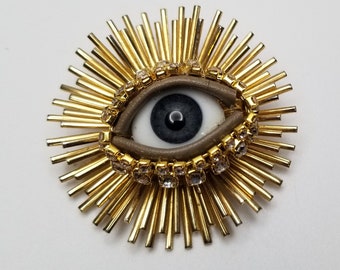 Mid Century Wink - Gold toned vintage brooch + glass doll eye. OOAK mixed media jewelry. Celestial symbol.