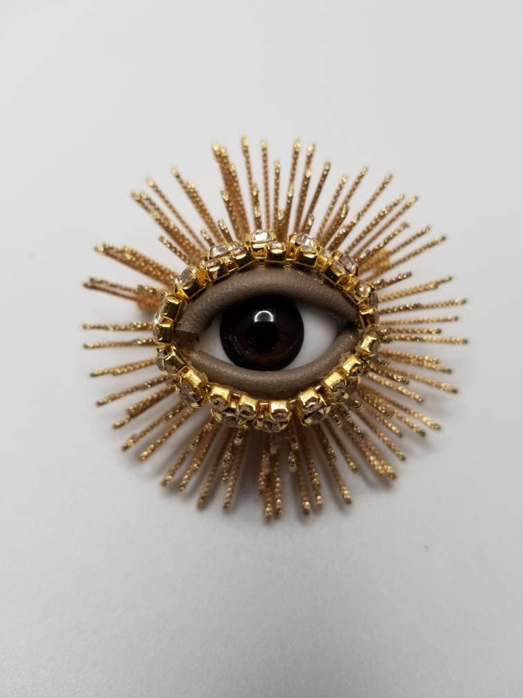 Sea Urchin Wink - Gold tone eyeball brooch pin