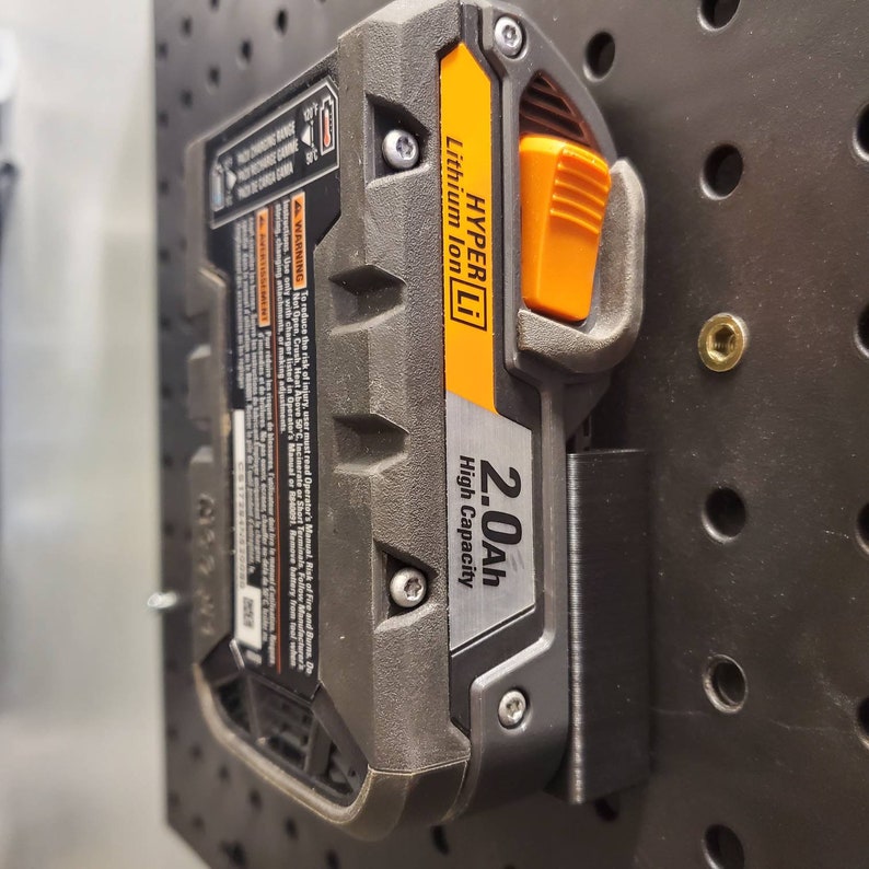 May include: A black and orange power tool battery with the text "HYPER Li Lithium Ion 2.0Ah High Capacity" on the side.