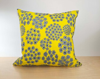 May include: Yellow throw pillow with a gray floral pattern.