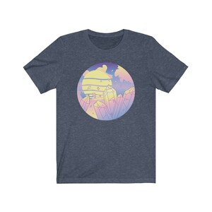 May include: A navy blue t-shirt with a pastel colored graphic of a sunset with crystals. The graphic is in a circle.