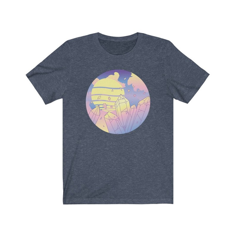 May include: A navy blue t-shirt with a pastel colored graphic of a sunset with crystals. The graphic is in a circle.
