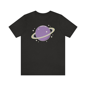 K&ouml;nnte beinhalten: Schwarzes T-Shirt mit einem lila Planeten mit einem Regenbogenring und wei&szlig;en Sternen.