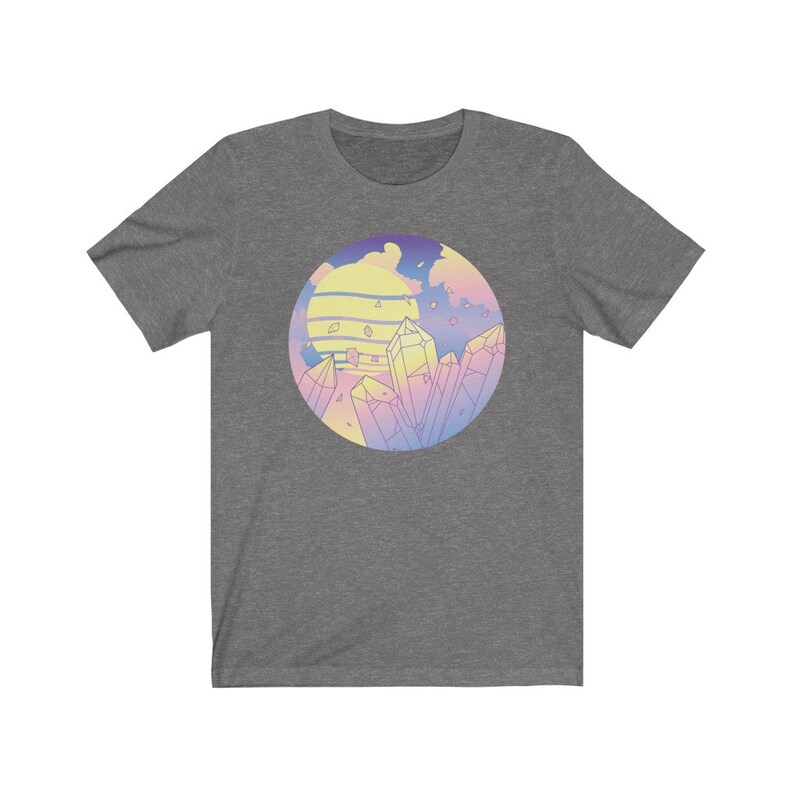 May include: A heather grey t-shirt with a pastel colored graphic of a sunset with crystals. The graphic is in a circle and has a pink, blue, and yellow color scheme.