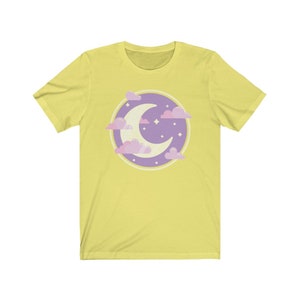 May include: A yellow short-sleeved t-shirt with a purple and pink crescent moon and clouds graphic.