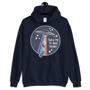 May include: Navy blue hoodie with a white graphic of a UFO, rainbow, and crystals. The text "Take Me To Your Healer" is printed on the graphic.