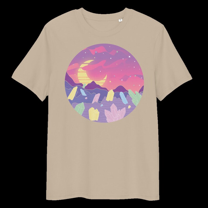 May include: A beige t-shirt featuring a graphic print of a crescent moon, a sunset, and crystals in a circle. The colours in the graphic are pink, purple, blue, yellow, and green.