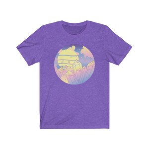 May include: Purple short-sleeved t-shirt with a graphic of a sunset with crystals in a circle. The sunset is in shades of pink, yellow, and blue. The crystals are in shades of pink, yellow, and blue.