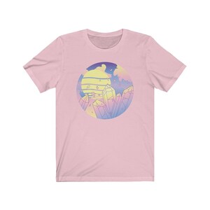 May include: Pink t-shirt with a graphic of a sunset and crystals in a circle. The crystals are in shades of pink, blue, and yellow.