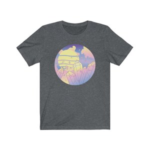 May include: A dark heather grey t-shirt with a pastel colored graphic of a sunset and crystals. The graphic is in a circle.