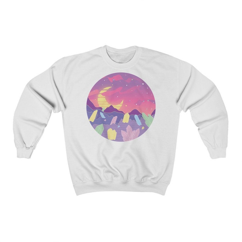 May include: White sweatshirt with a colorful graphic print of a crescent moon, mountains, and crystals against a pink and purple sunset sky.