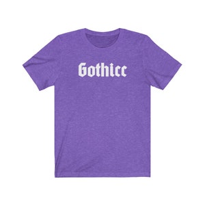 May include: Purple short-sleeved t-shirt with the word "Gothicc" printed in white in a gothic font.