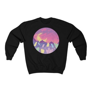 May include: Black sweatshirt with a circular graphic of a crescent moon, pink and purple mountains, and colorful crystals against a sunset sky.
