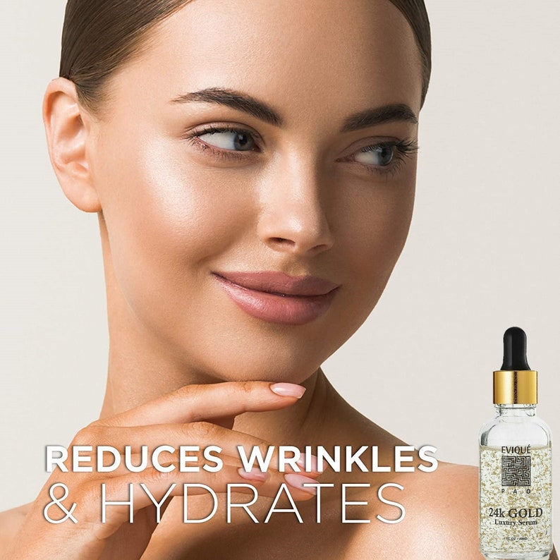 May include: A clear glass bottle with a gold cap and a dropper. The bottle contains a gold liquid with flecks of gold. The bottle is labeled "EVOIQU&Eacute; 24k GOLD Luxury Serum". The text "REDUCES WRINKLES & HYDRATES" is in large white letters on a black background.