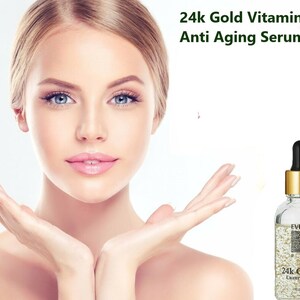 May include: A clear glass bottle with a gold cap and a gold label that says "EVIQUE 24K GOLD Luxury Serum". The bottle is filled with a clear liquid with gold flakes. The bottle is on a white background.