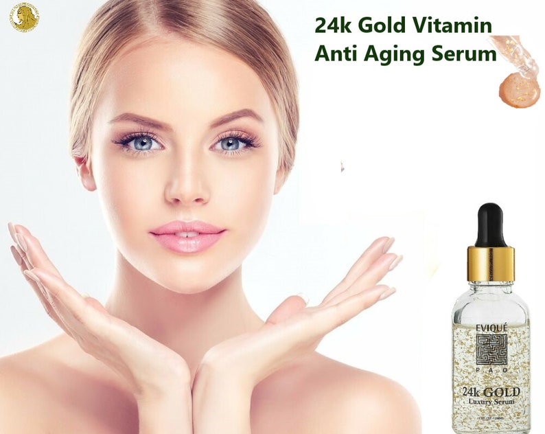May include: A clear glass bottle with a gold cap and a gold label that says "EVIQUE 24K GOLD Luxury Serum". The bottle is filled with a clear liquid with gold flakes. The bottle is on a white background.