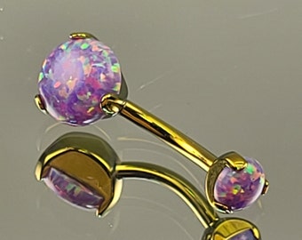 May include: Gold belly button ring with two purple opal stones.