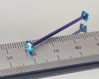 May include: A blue titanium barbell with two blue gemstones. The barbell is measured against a ruler, showing it is approximately 60mm long.