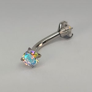 May include: A silver body piercing with a clear iridescent gem on each end. The gem is set in a prong setting.