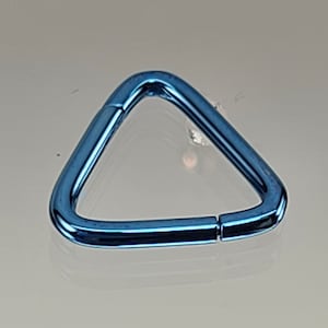 May include: A blue triangle-shaped metal ring with a smooth finish. The ring is open on one side and can be used for attaching items.
