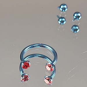 16g (1.2mm) Ice Blue Titanium Horseshoe Internally Threaded w/4mm Fire Red Prong-Set Gems Septum Anodized Finish 3/8" (10mm) Diameter