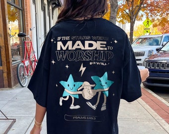 May include: Black oversized t-shirt with a graphic of two blue stars holding hands. The text on the shirt reads "If the stars were made to worship so will I." and "Psalms 148:3".