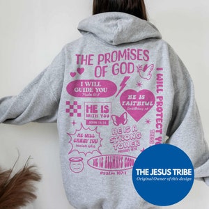 May include: A gray hoodie with pink text and graphics. The back of the hoodie features the words "THE PROMISES OF GOD" and various inspirational phrases and Bible verses. A blue circle with the text "THE JESUS TRIBE" is at the bottom.