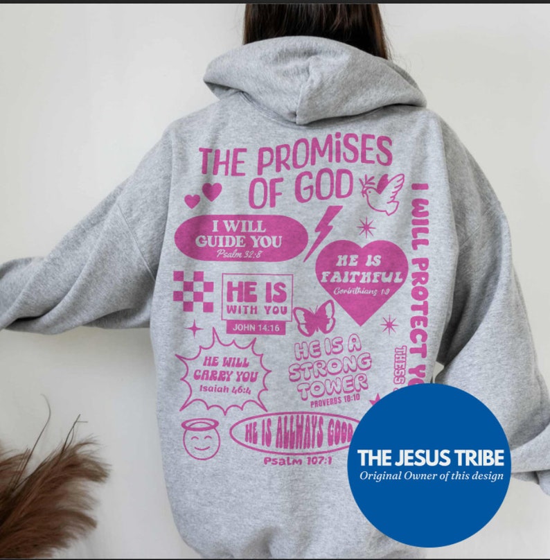 May include: A gray hoodie with pink text and graphics. The back of the hoodie features the words "THE PROMISES OF GOD" and various inspirational phrases and Bible verses. A blue circle with the text "THE JESUS TRIBE" is at the bottom.