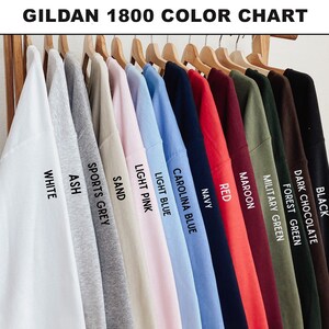 May include: A color chart of Gildan 1800 sweatshirts in various colors, including white, ash, sports grey, sand, light pink, light blue, Carolina blue, navy, red, maroon, military green, forest green, dark chocolate, and black. The text "GILDAN 1800 COLOR CHART" is at the top.
