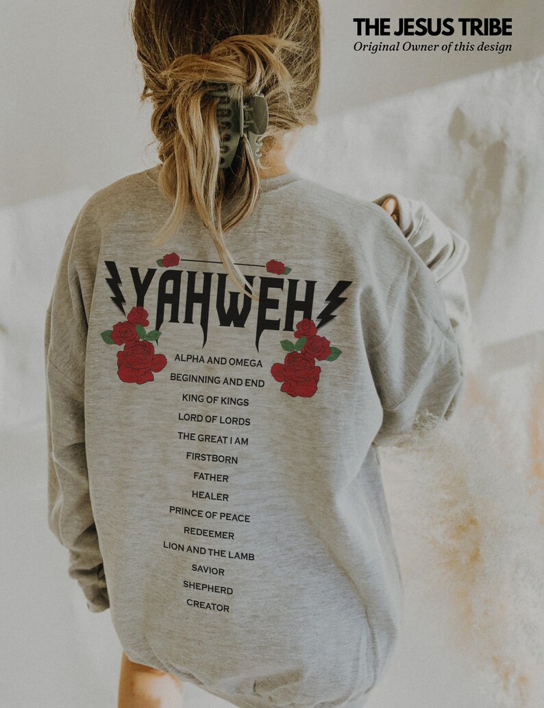 May include: Grey sweatshirt with the word "YAHWEH" printed in black with lightning bolts on either side. The word is surrounded by red roses. Below the word are the words "ALPHA AND OMEGA", "BEGINNING AND END", "KING OF KINGS", "LORD OF LORDS", "THE GREAT I AM", "FIRSTBORN", "FATHER", "HEALER", "PRINCE OF PEACE", "REDEEMER", "LION AND THE LAMB", "SAVIOR", "SHEPHERD", "CREATOR".