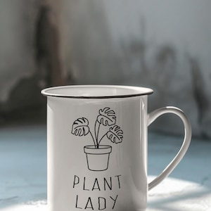 May include: White enamel mug with a black outline of a potted plant and the text "Plant Lady".