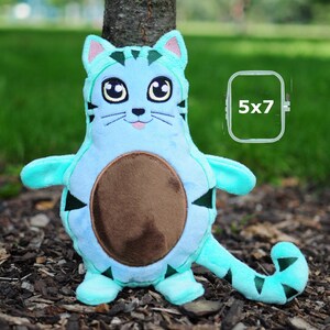 May include: A turquoise blue plush cat toy with black stripes and a brown felt belly patch. The toy is designed for embroidery and is 5x7 inches.
