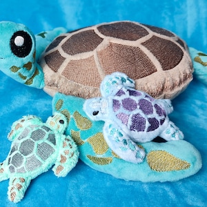 May include: Three plush sea turtle toys. The largest turtle is light blue with a brown shell. The medium turtle is light blue with a purple shell. The smallest turtle is light green with a gray shell.