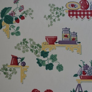 May include: Vintage wallpaper pattern featuring a white background with repeating images of shelves with various kitchen items, including a scale, jars, a rolling pin, a bowl, a pitcher, and fruit. The shelves are decorated with a red and white checkered tablecloth and yellow brackets. The wallpaper also features green leafy vines.