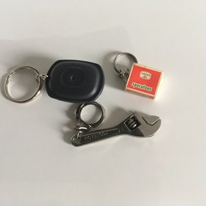 Set of 3 keychains ( Tupperware/lotus biscuit/ Postillon adjustable wrench ) very good condition