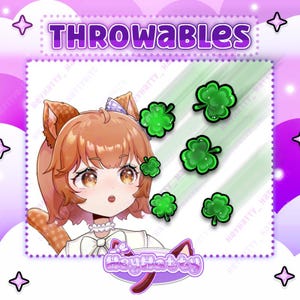 May include: A digital illustration of a cartoon character with brown hair and ears, wearing a white dress with a bow and a cat-like headband. The character is surrounded by green four-leaf clover shapes. The text "THROWABLES" is at the top of the image. The text "HeyHatty" is at the bottom of the image.