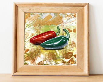 May include: A framed painting of two peppers, one red and one green, on a textured background. The peppers are painted in a realistic style.