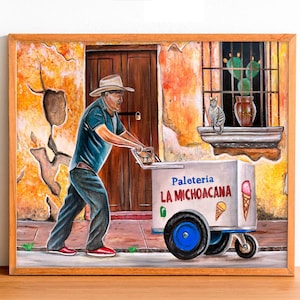 May include: A framed painting depicts a man pushing an ice cream cart labeled "Paleteria La Michoacana." The cart has blue wheels and an ice cream cone graphic. The background shows a weathered building with a window and a cat.