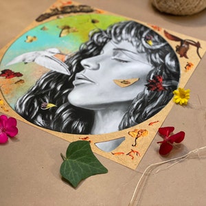 May include: A circular illustration on a brown background featuring a woman's face in the centre. The woman has long dark hair and closed eyes. The background is a collage of leaves, flowers, and other natural elements.