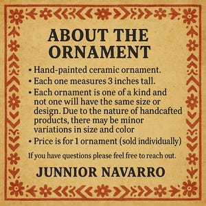 May include: A tan-colored card with a decorative border and text. The text reads "ABOUT THE ORNAMENT" followed by details about the hand-painted ceramic ornament, including its 3-inch height and unique, handcrafted nature.
