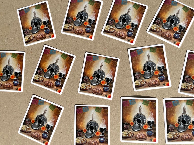 May include: A set of 10 stickers featuring a Day of the Dead altar with a sugar skull, candles, and offerings. The stickers are printed on white paper with a glossy finish.