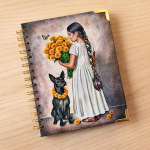 May include: Spiral-bound notebook featuring a watercolor illustration. A woman in a white dress holds a bouquet of orange flowers, with a black dog wearing a flower collar. A butterfly hovers nearby.
