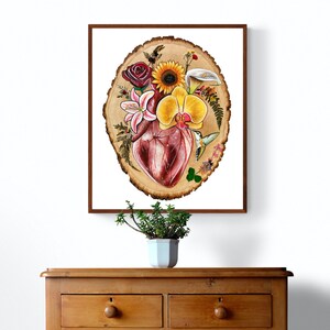 May include: A painting of a human heart surrounded by flowers and a hummingbird on a wood slice background.