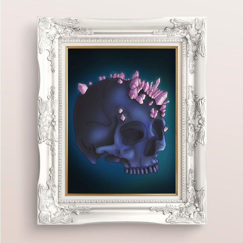 May include: A dark blue skull with pink crystal accents on top, set against a dark blue background. The skull is in a white ornate frame.
