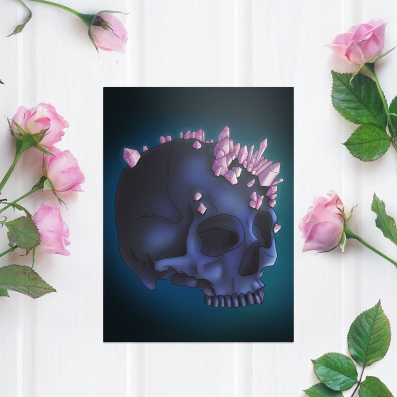 May include: A dark blue human skull with a crown of pink crystals on top. The skull is set against a dark blue background.