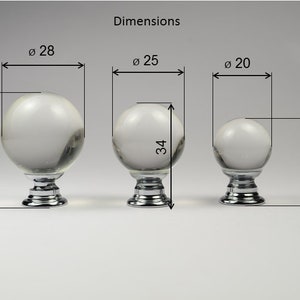 May include: Three clear glass knobs with chrome bases. The knobs are 28, 25, and 20 inches in diameter. The heights are 38, 34, and 29 inches.