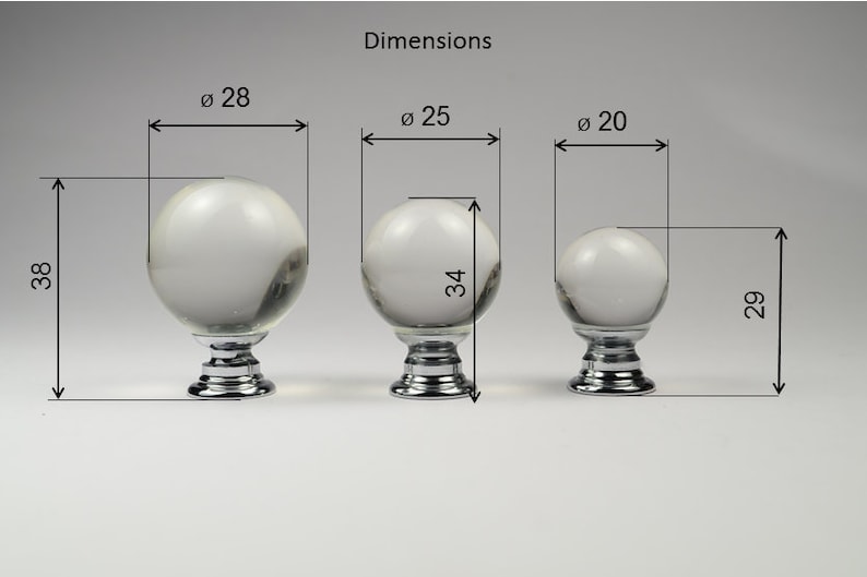 May include: Three clear glass knobs with chrome bases. The knobs are 28, 25, and 20 inches in diameter. The heights are 38, 34, and 29 inches.