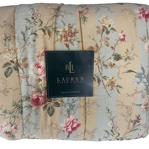 May include: A floral comforter with a light blue and beige striped background. The comforter features a pattern of pink, beige, and blue flowers and green leaves. The comforter has a dark green label with the text "RL LAUREN".